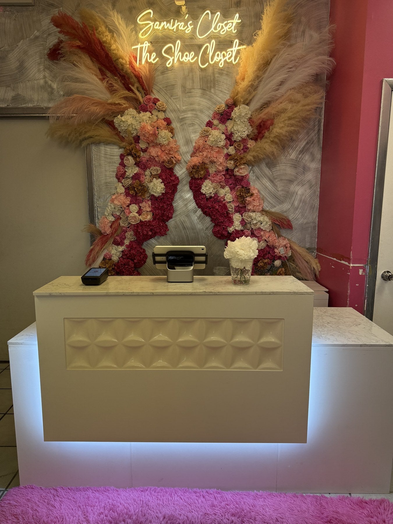 Samira’s Closet boutique flower wall and styling area